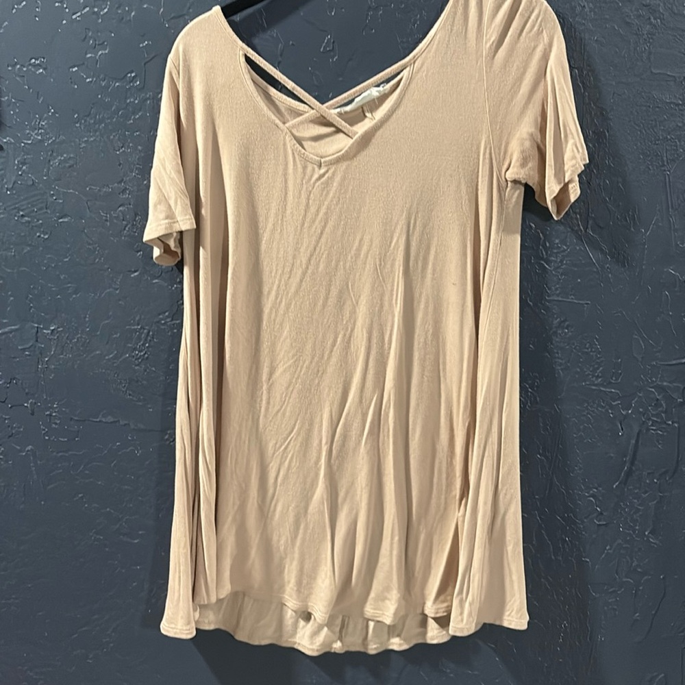Pinkish/beige top with x across chest